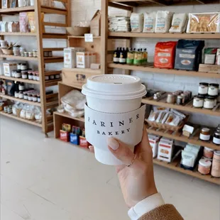 a hand holding a cup of coffee