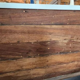 Plugged holes covering fasteners (screws?) holding hull planking in place.