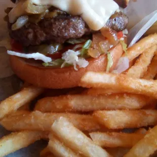 Farley's Mesilla Mex Burger with fries. A big half pound burger, a bit dry, not juicy, and lacking seasoning. Rate it a "B" or "B+."