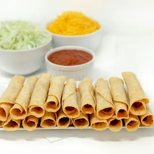 Clucketos--These crispy chicken taquitos are packed with flavor and smothered in fresh grated cheese, crispy lettuce, and zesty salsa.