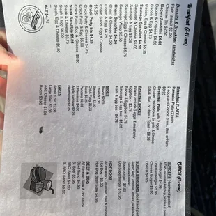 a hand holding a menu