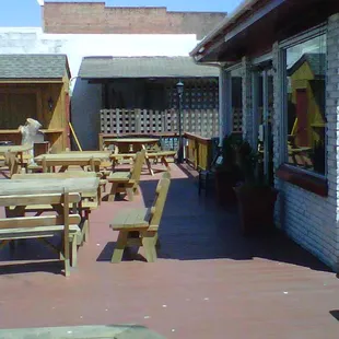 a patio with tables and benches