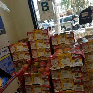 a large stack of fruit in a grocery store