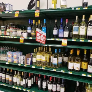 a large selection of wines on shelves