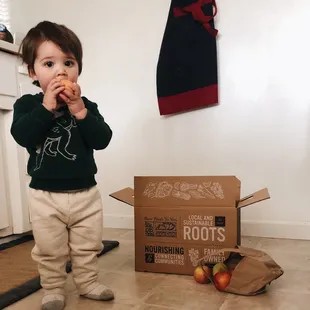 Look at this cute kid with our Traditional CSA box :)