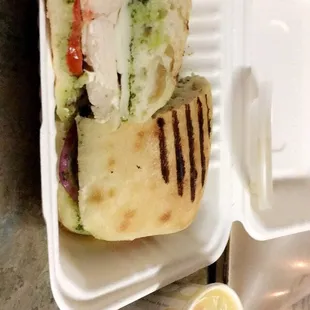 a chicken sandwich in a styrofoam container