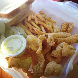 a basket of fried fish and fries