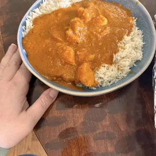 a plate of rice and chicken curry