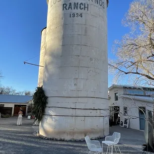 a white silo with a sign on it