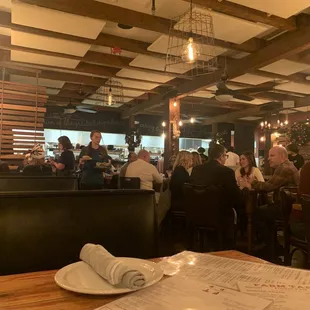 people sitting at tables in a restaurant