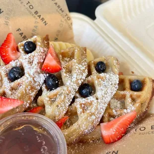 a waffle with strawberries and blueberries