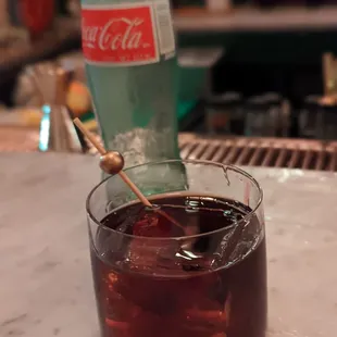 a bottle of coke and a spoon