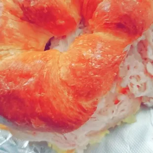 a croissant sandwich on tin foil