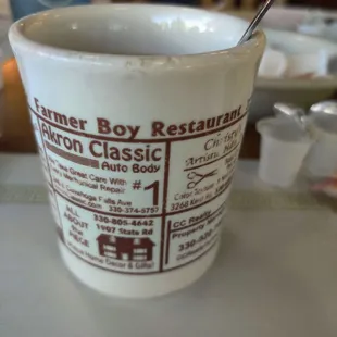 a coffee cup with a spoon in it