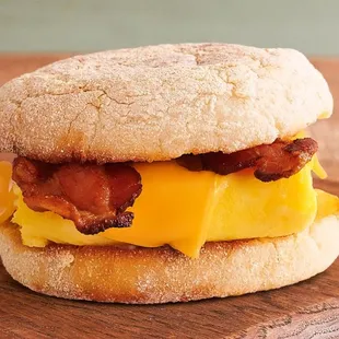 an english muffin with bacon and cheese