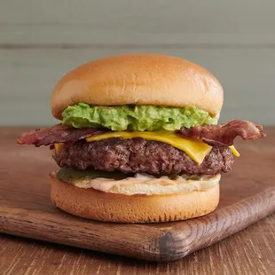 a hamburger with bacon, lettuce, and cheese