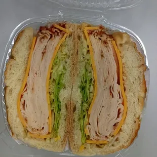 Buffalo chicken with cheddar and lettuce on a roll.