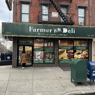a man walking in front of a deli