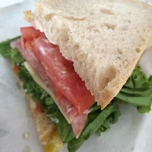 a sandwich with tomatoes and lettuce