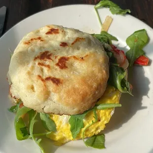 Egg and veggies on a biscuit. It&apos;s large with 2 eggs, a fork and knife operation!