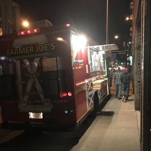 a food truck parked on the side of the road