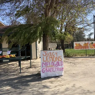 a sign in front of a farmers market