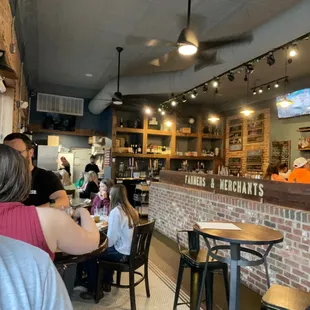 people sitting at tables in a restaurant