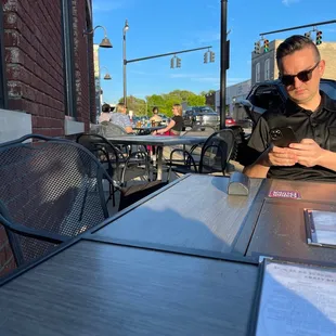 a man sitting at a table outside