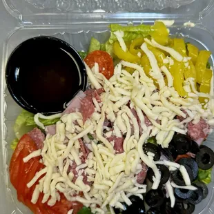 Antipasto Salad - 
Romaine, Salami, Ham, Pepperoni, Kalamata Olives, Tomatoes, Pepperoncini, Mozzarella Cheese and Italian Dressing
