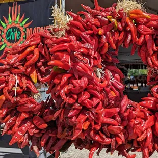 red chile ristra wreaths in front of Farmers Chile Market sign