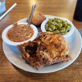 Fried pork chops, green beans, pinto beans and cornbread
