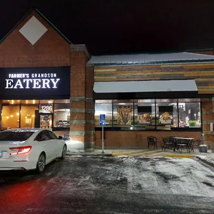 a car parked in front of a restaurant