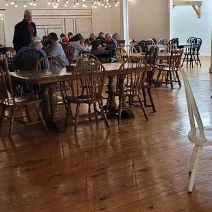people sitting at tables in a restaurant