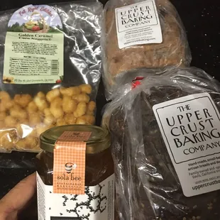two packages of bread, a jar of honey, and nuts