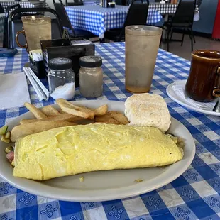Vegetable omelette with biscuit and fries. These are not the home fries as they had run out.