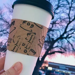 a hand holding a cup of coffee