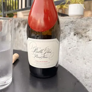 a bottle of wine and a glass of water