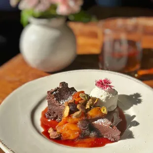Warm Chocolate Truffle Cake mixed berries, red wine sauce, sweet cream, toasted pistachios