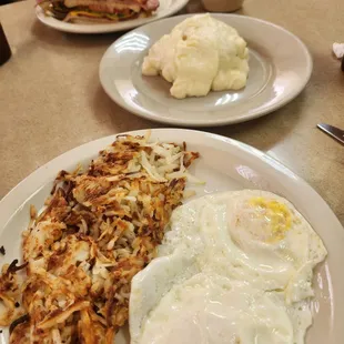 Hash browns, eggs, biscuits and gravy; club sandwich