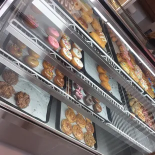 a display case with a variety of doughnuts