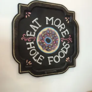 a chalkboard sign with a donut on it