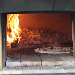 Our wood-fired pizza oven at work!