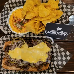 Cheese steak sandwich and beer cheese queso.