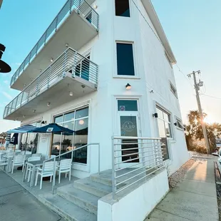 a view of a white building with a balcony