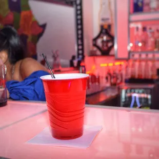 a red cup with a straw sticking out of it