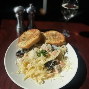 Seafood Alfredo medley with mussels, salmon, cod, rockfish, baby scallops and clams