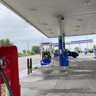 a gas station with a red fire hydrant