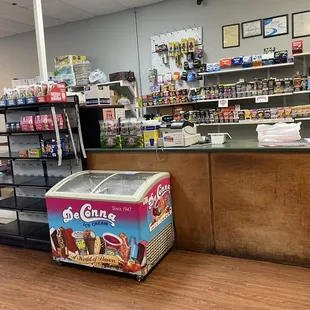 Counter with tobacco products behind and ice cream in front