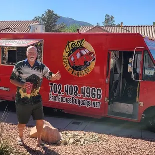 a man standing in front of a food truck