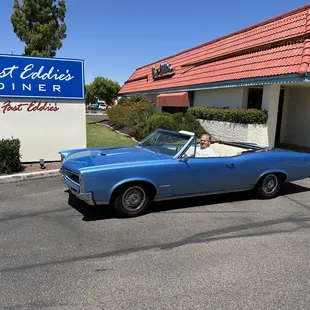 a classic car parked in front of a fast eddie&apos;s diner